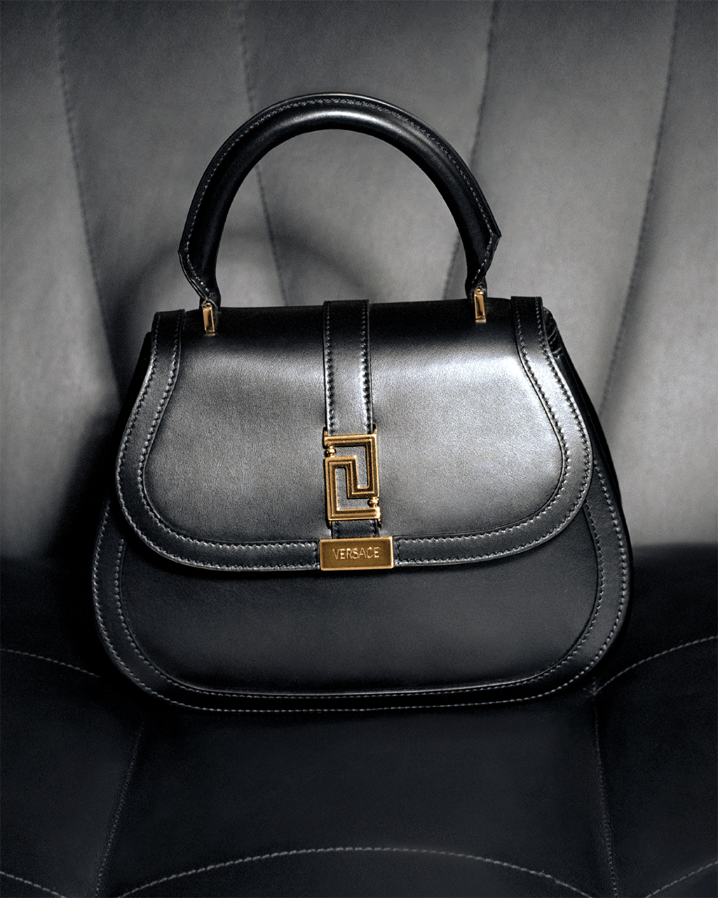 The Versace Greca Goddess top handle bag is from a higher being