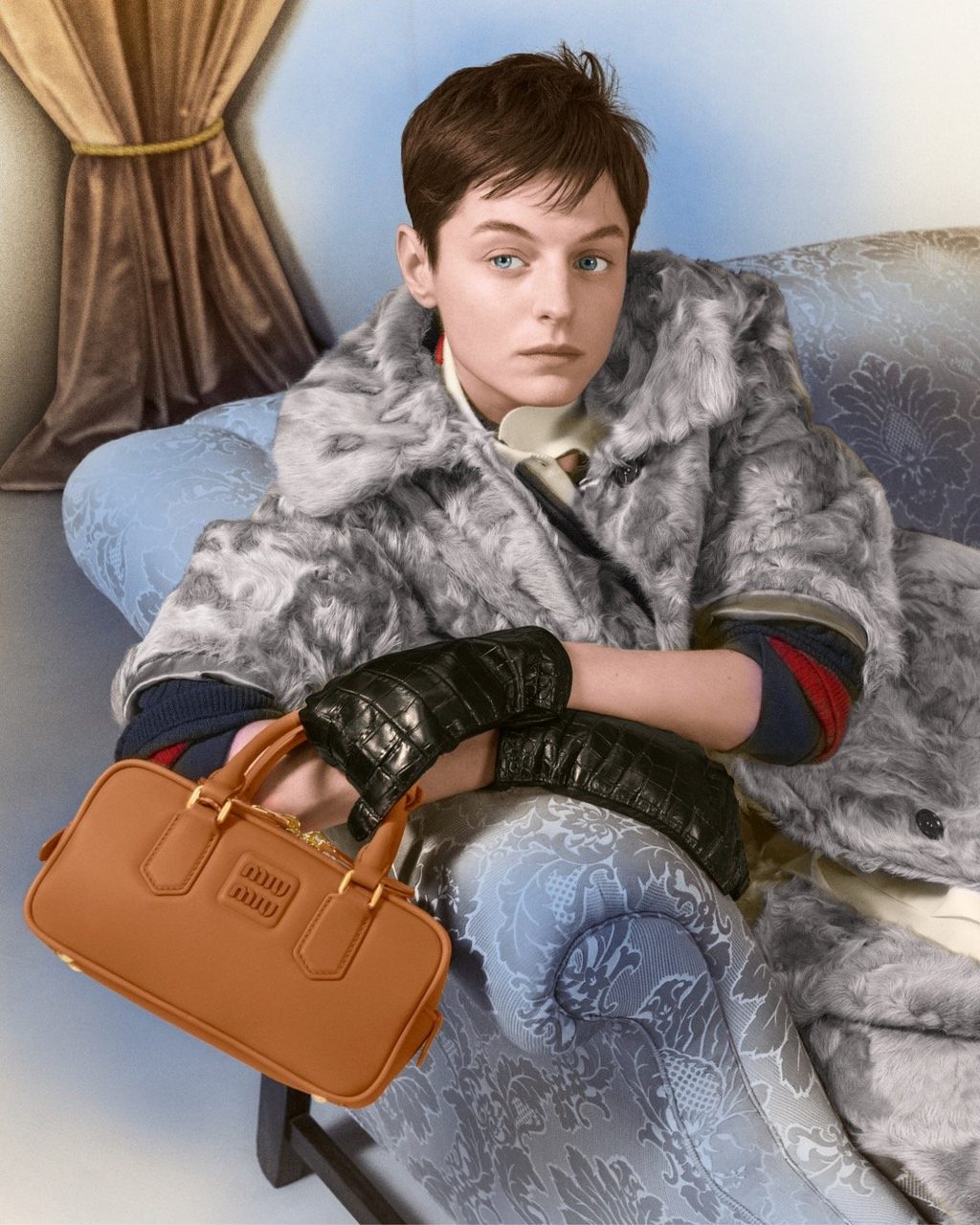 Actress Emma Corrin appears in Sapphire Blue for Miu Miu's 2024 Holiday Campaign